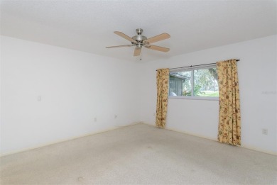 Tucked beneath the shade of moss-draped oaks and overlooking on Tarpon Woods Golf Club in Florida - for sale on GolfHomes.com, golf home, golf lot