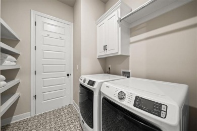 Welcome to this exceptional reverse 1.5-story walkout home in on Fred Arbanas Golf Course At Longview Lakes - Longview Lake in Missouri - for sale on GolfHomes.com, golf home, golf lot
