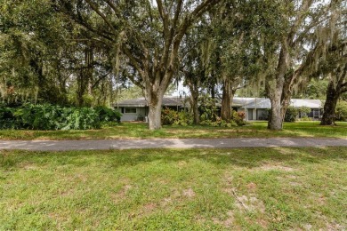 Tucked beneath the shade of moss-draped oaks and overlooking on Tarpon Woods Golf Club in Florida - for sale on GolfHomes.com, golf home, golf lot