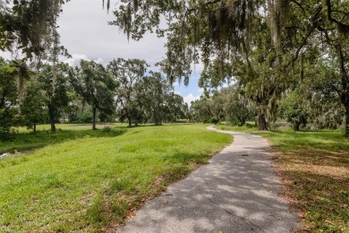 Tucked beneath the shade of moss-draped oaks and overlooking on Tarpon Woods Golf Club in Florida - for sale on GolfHomes.com, golf home, golf lot