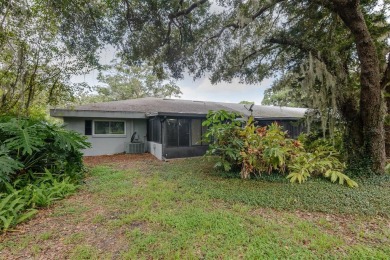 Tucked beneath the shade of moss-draped oaks and overlooking on Tarpon Woods Golf Club in Florida - for sale on GolfHomes.com, golf home, golf lot