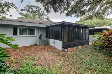 Tucked beneath the shade of moss-draped oaks and overlooking on Tarpon Woods Golf Club in Florida - for sale on GolfHomes.com, golf home, golf lot
