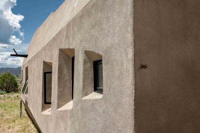 Live inside a work of art in this  Artist's Dream Dwelling in on Taos Country Club in New Mexico - for sale on GolfHomes.com, golf home, golf lot