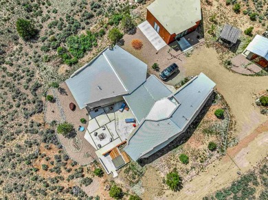 Live inside a work of art in this  Artist's Dream Dwelling in on Taos Country Club in New Mexico - for sale on GolfHomes.com, golf home, golf lot