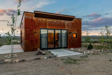Live inside a work of art in this  Artist's Dream Dwelling in on Taos Country Club in New Mexico - for sale on GolfHomes.com, golf home, golf lot