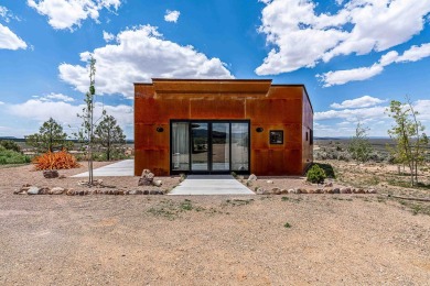 Live inside a work of art in this  Artist's Dream Dwelling in on Taos Country Club in New Mexico - for sale on GolfHomes.com, golf home, golf lot