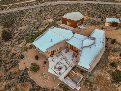Live inside a work of art in this  Artist's Dream Dwelling in on Taos Country Club in New Mexico - for sale on GolfHomes.com, golf home, golf lot