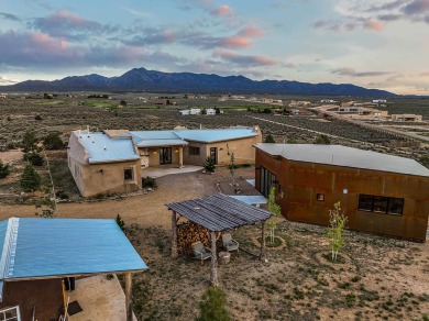Live inside a work of art in this  Artist's Dream Dwelling in on Taos Country Club in New Mexico - for sale on GolfHomes.com, golf home, golf lot