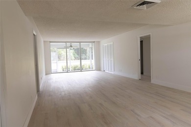 Take a look at this beautiful condo in Palm Aire with new floors on Palm-Aire Country Club and Resort - Palms in Florida - for sale on GolfHomes.com, golf home, golf lot