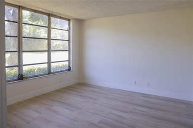 Take a look at this beautiful condo in Palm Aire with new floors on Palm-Aire Country Club and Resort - Palms in Florida - for sale on GolfHomes.com, golf home, golf lot