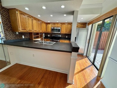 Move-in ready in the heart of Davie close to highways on Pine Island Ridge Country Club in Florida - for sale on GolfHomes.com, golf home, golf lot