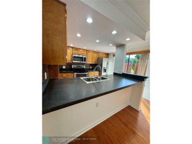Move-in ready in the heart of Davie close to highways on Pine Island Ridge Country Club in Florida - for sale on GolfHomes.com, golf home, golf lot