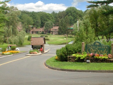 Enjoy the spectacular direct pond views from this ranch End Unit on Farmington Woods Country Club in Connecticut - for sale on GolfHomes.com, golf home, golf lot