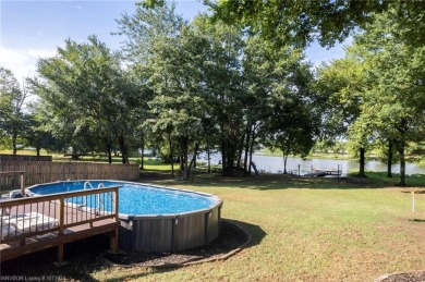 Enjoy this lakefront home in all seasons! Fish off the dock and on Vache-Grasse Country Club in Arkansas - for sale on GolfHomes.com, golf home, golf lot