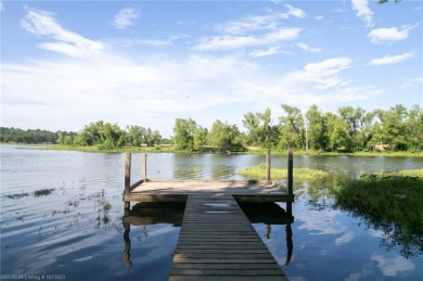 Enjoy this lakefront home in all seasons! Fish off the dock and on Vache-Grasse Country Club in Arkansas - for sale on GolfHomes.com, golf home, golf lot