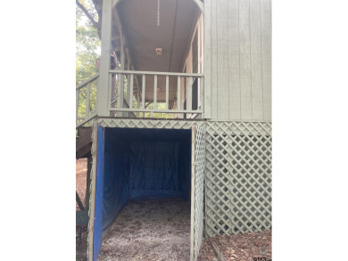 This one-owner home sits on three wooded lots for a total of .75 on Holly Lake Ranch Golf Club in Texas - for sale on GolfHomes.com, golf home, golf lot