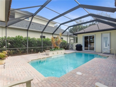 This courtyard pool home is nestled on a lush golf course on Indian River Club in Florida - for sale on GolfHomes.com, golf home, golf lot