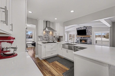 This completely updated Colonial overlooking the #12 Green at on Travis Pointe Country Club in Michigan - for sale on GolfHomes.com, golf home, golf lot