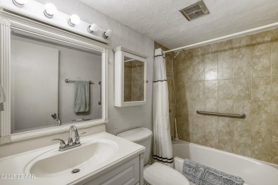 Enjoy easy living in this beautifully furnished 2-bedroom on Daytona Beach Golf Club in Florida - for sale on GolfHomes.com, golf home, golf lot