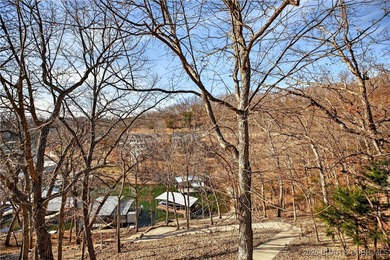 This stunning lakefront home in Four Seasons offers 75 feet of on Seasons Ridge At Four Seasons in Missouri - for sale on GolfHomes.com, golf home, golf lot