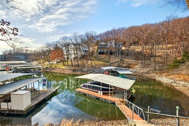 This stunning lakefront home in Four Seasons offers 75 feet of on Seasons Ridge At Four Seasons in Missouri - for sale on GolfHomes.com, golf home, golf lot