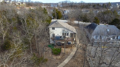 This stunning lakefront home in Four Seasons offers 75 feet of on Seasons Ridge At Four Seasons in Missouri - for sale on GolfHomes.com, golf home, golf lot