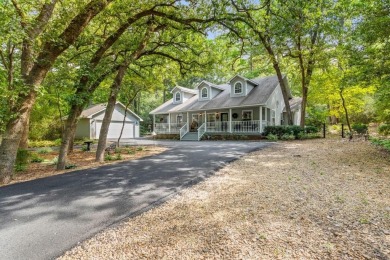 Southern charm meets this 3BR 2BA  Cape Cod style cottage tucked on Holly Lake Ranch Golf Club in Texas - for sale on GolfHomes.com, golf home, golf lot