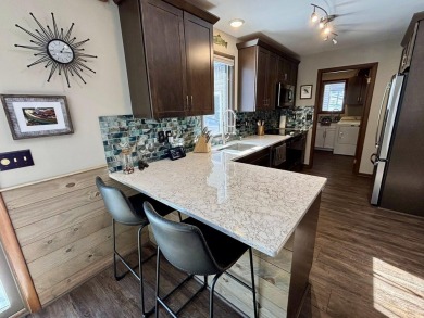Private northern MI retreat! Renovated 1,428 sq ft chalet on 2 on The Loon Golf Resort in Michigan - for sale on GolfHomes.com, golf home, golf lot