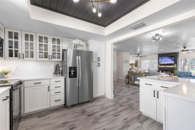 Step inside and exhale--from morning coffee by the pool to on Palm Harbor Golf Club in Florida - for sale on GolfHomes.com, golf home, golf lot