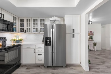 Step inside and exhale--from morning coffee by the pool to on Palm Harbor Golf Club in Florida - for sale on GolfHomes.com, golf home, golf lot