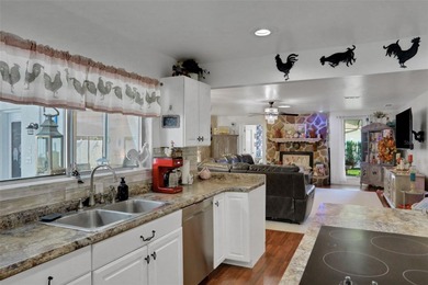 Welcome to this stunning home, where warmth and elegance await on The Grand Club - Pine Lakes Course in Florida - for sale on GolfHomes.com, golf home, golf lot