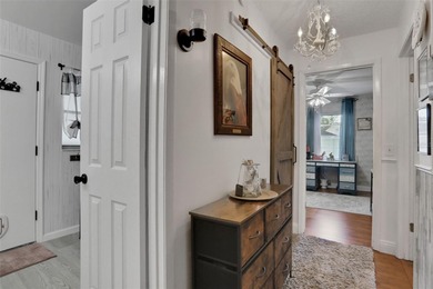 Welcome to this stunning home, where warmth and elegance await on The Grand Club - Pine Lakes Course in Florida - for sale on GolfHomes.com, golf home, golf lot