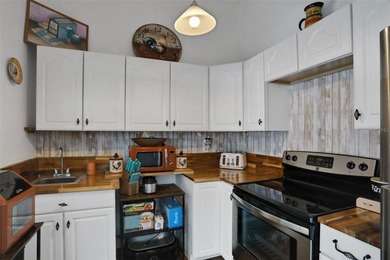 Welcome to this stunning home, where warmth and elegance await on The Grand Club - Pine Lakes Course in Florida - for sale on GolfHomes.com, golf home, golf lot