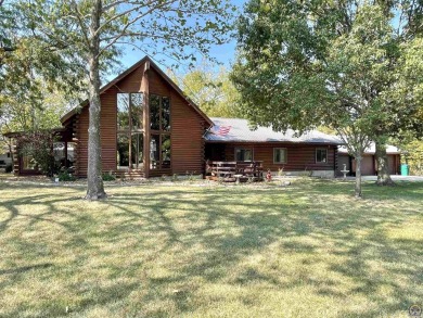 Opportunity awaits! Gorgeous log home living on a quiet street on Lake Perry Country Club in Kansas - for sale on GolfHomes.com, golf home, golf lot