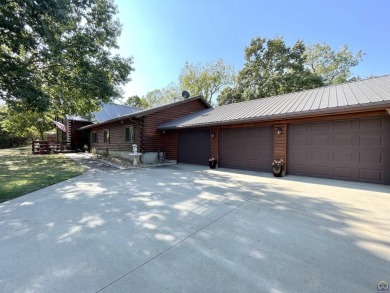 Opportunity awaits! Gorgeous log home living on a quiet street on Lake Perry Country Club in Kansas - for sale on GolfHomes.com, golf home, golf lot