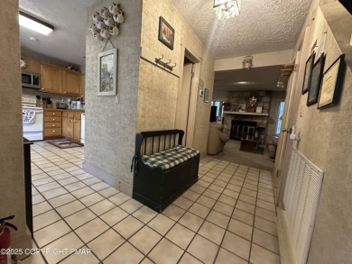 Welcome to 844 Crest Pine Lane - a charming 3-bedroom, 2.5 bath on Pinecrest Lake Golf and Country Club in Pennsylvania - for sale on GolfHomes.com, golf home, golf lot