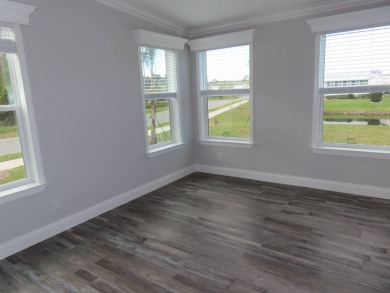 This never owned new Palm Harbor Black Diamond model is ready on Crane Lakes Golf and Country Club in Florida - for sale on GolfHomes.com, golf home, golf lot