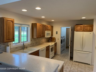 Mountain and golf course views make this light filled open floor on Buck Hill Golf Club  in Pennsylvania - for sale on GolfHomes.com, golf home, golf lot