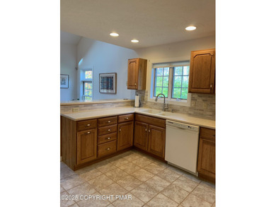 Mountain and golf course views make this light filled open floor on Buck Hill Golf Club  in Pennsylvania - for sale on GolfHomes.com, golf home, golf lot