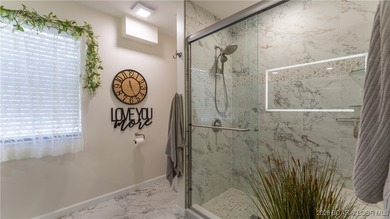 Beautifully updated waterfront condominium with stunning lake on Seasons Ridge At Four Seasons in Missouri - for sale on GolfHomes.com, golf home, golf lot