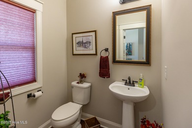 Situated along the fairways of the Woods Golf Course in on Whispering Woods in North Carolina - for sale on GolfHomes.com, golf home, golf lot