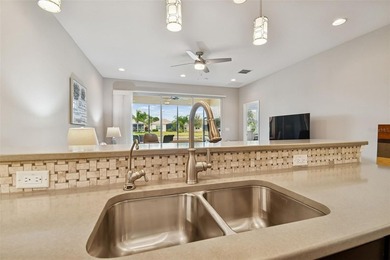 An opportunity to own a Nantucket model villa with a water view on Caloosa Greens Executive Golf Course in Florida - for sale on GolfHomes.com, golf home, golf lot