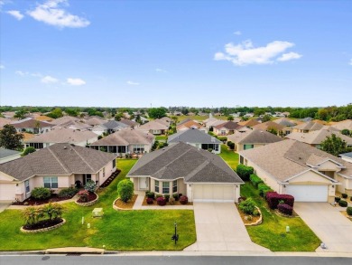 Welcome to this beautifully maintained Challedon model home in on Eagle Ridge At Spruce Creek Country Club in Florida - for sale on GolfHomes.com, golf home, golf lot