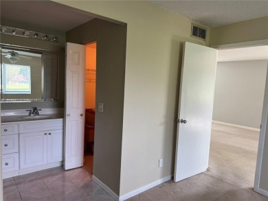 Discover the potential of this spacious 2 BR, 2 BTH corner condo on Sunrise Lakes Phase III in Florida - for sale on GolfHomes.com, golf home, golf lot