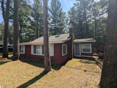 A cute two bedroom cottage sitting on a wide lot with sandy on Huron Breeze Golf Club in Michigan - for sale on GolfHomes.com, golf home, golf lot