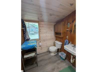 A cute two bedroom cottage sitting on a wide lot with sandy on Huron Breeze Golf Club in Michigan - for sale on GolfHomes.com, golf home, golf lot