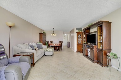 Sun-splashed and move-in ready, this airy second-floor residence on Fountains Golf and Country Club in Florida - for sale on GolfHomes.com, golf home, golf lot