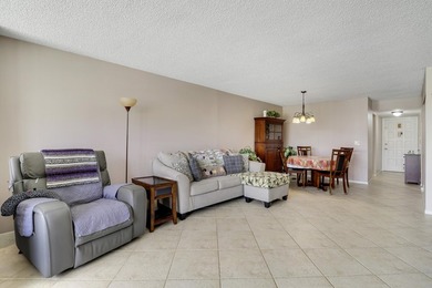 Sun-splashed and move-in ready, this airy second-floor residence on Fountains Golf and Country Club in Florida - for sale on GolfHomes.com, golf home, golf lot