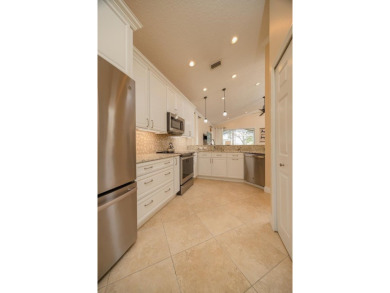 Bright,Cheerful & Immaculate Waterfront Home In Premier 55+ on Slammer and Squire Golf Course in Florida - for sale on GolfHomes.com, golf home, golf lot