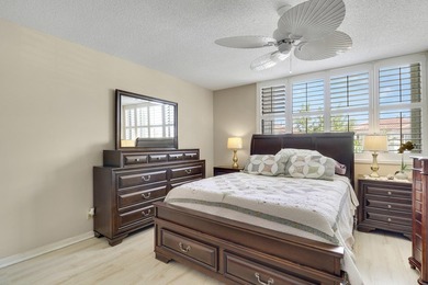 Sun-splashed and move-in ready, this airy second-floor residence on Fountains Golf and Country Club in Florida - for sale on GolfHomes.com, golf home, golf lot